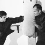 Lee-Bruce-hits-punching-bag-with-training-partner-Dan-Inosanto